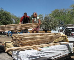 Sonny and Anna unloading the stacks of Myrtlewood flooring on May 9. The flooring needed to acclimate for a few weeks before installation.