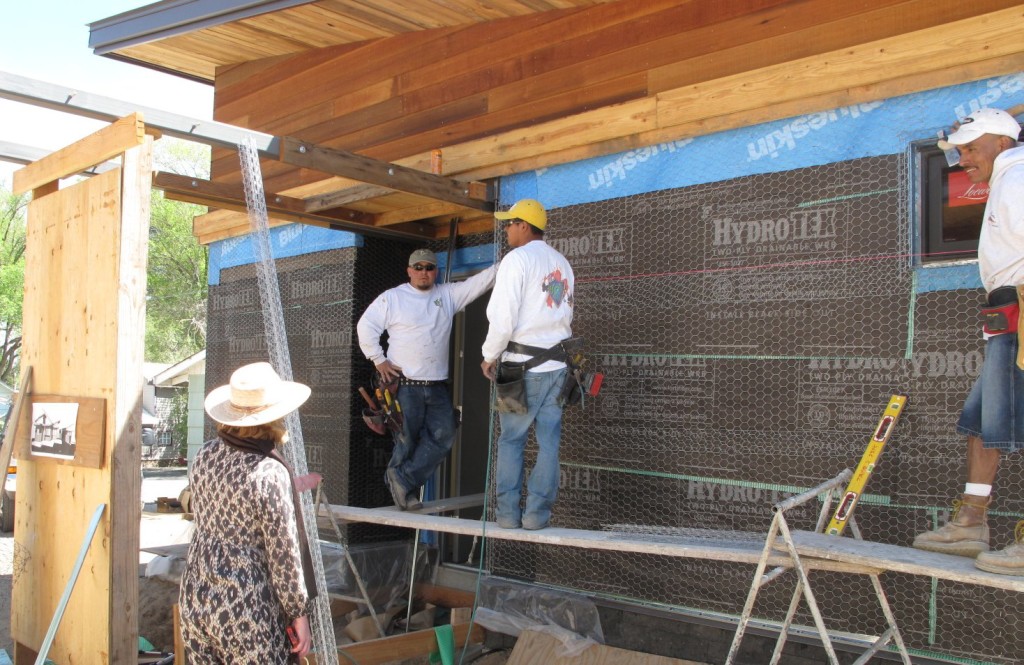 Barb visits with some of the crew as they install lathe on the garage.