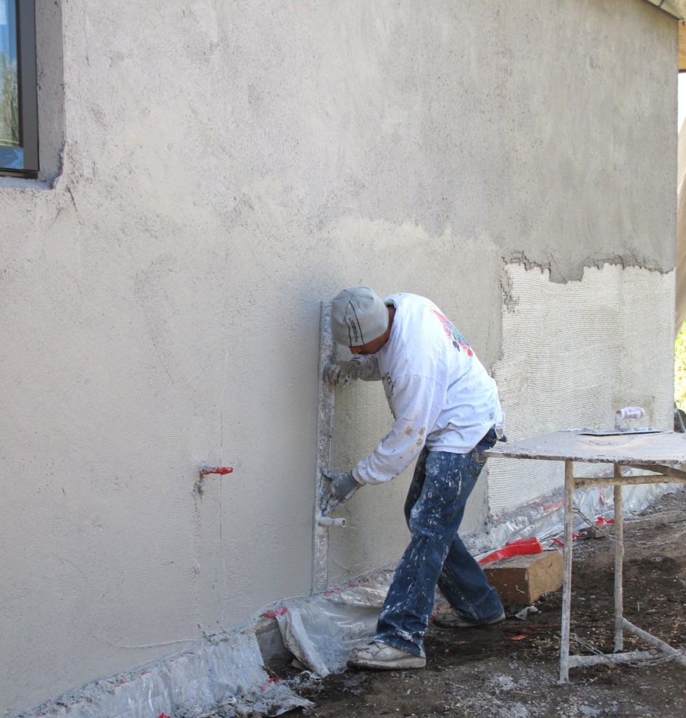 Juan working on the second coat of the main house.