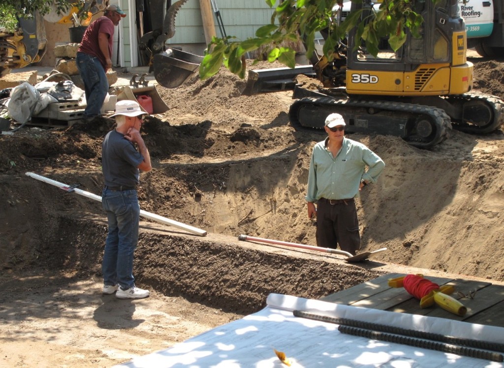 Morgan Brown (right) and Patrick Fitzgerald with Whole Water Systems stand in the wetland that has been pending approval for many, many months.