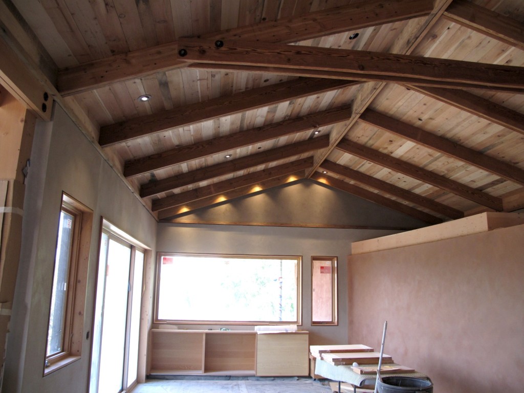 The living space in the main house showing the reclaimed wood ceiling in the glow of the LED lighting.