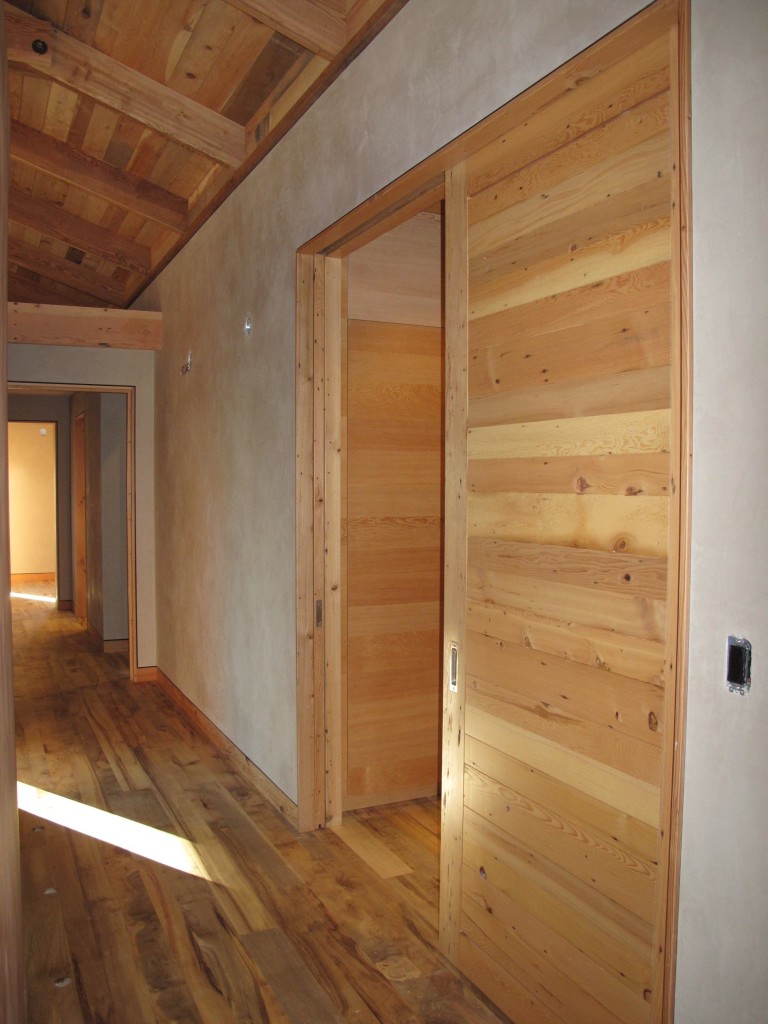 Doors, floors, ceilings, and trim use reclaimed and salvaged wood.
